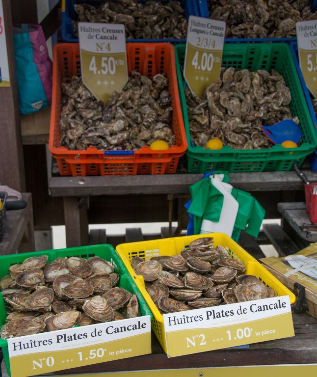 Fresh Huitres Plates de Cancale oysters for sale at Cancale market, priced by size