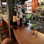 Parlor Bologna bar counter with Amaro Montenegro and Select Aperitivo bottles, jiggers, and stocked spirit shelves