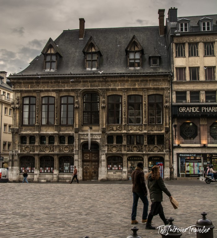 Historic Gothic facade on Place du Vieux-Marché, Rouen, with pedestrians crossing the cobblestone square