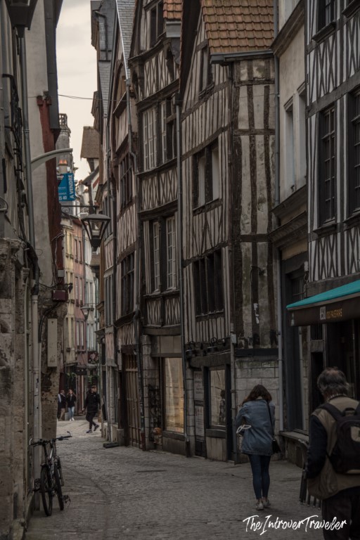 Narrow cobblestone street lined with medieval half-timbered buildings in Rouen, Normandy