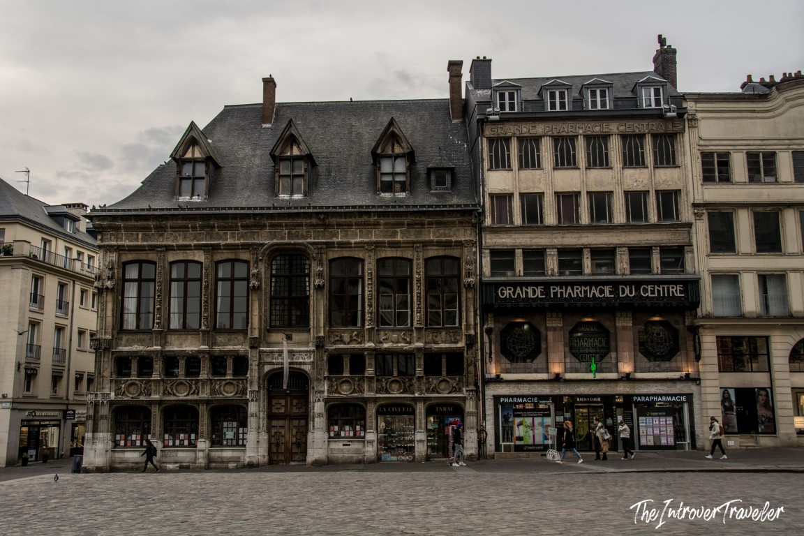 Historic Renaissance facade and Grande Pharmacie du Centre on a cobblestone square in Rouen, Normandy