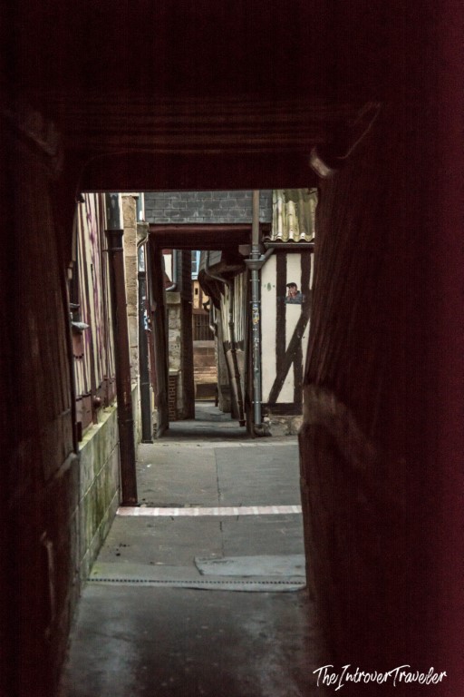 Narrow medieval passageway between half-timbered buildings in old Rouen, Normandy