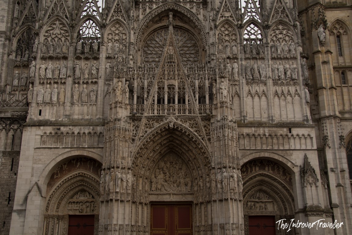 Rouen Cathedral Gothic facade, with ornate arches, stone carvings, and rows of saints, Normandy France