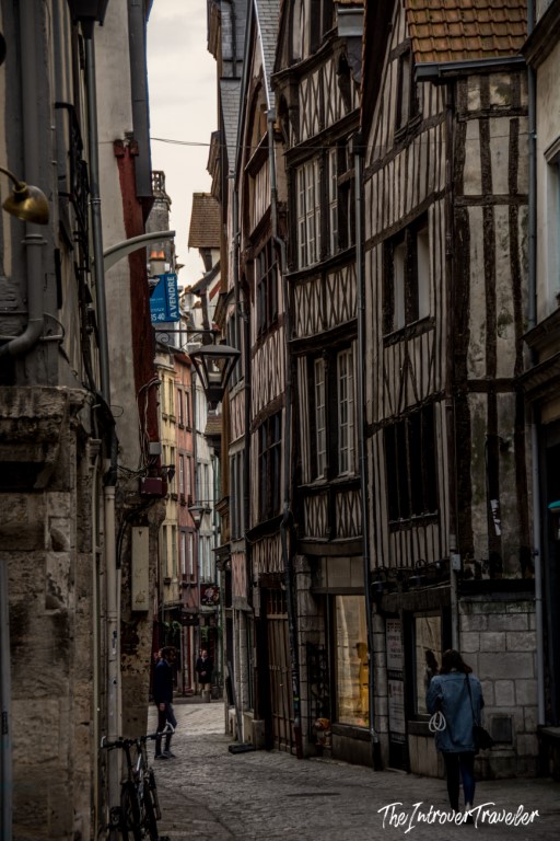 Narrow cobblestone street in Rouen lined with medieval half-timbered buildings, Normandy France