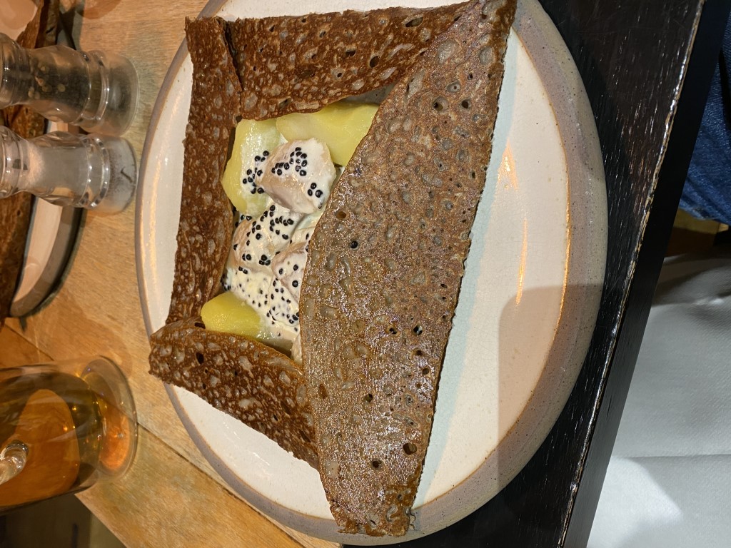 Buckwheat galette with smoked fish, potato, and caviar cream, served in Cancale, Brittany