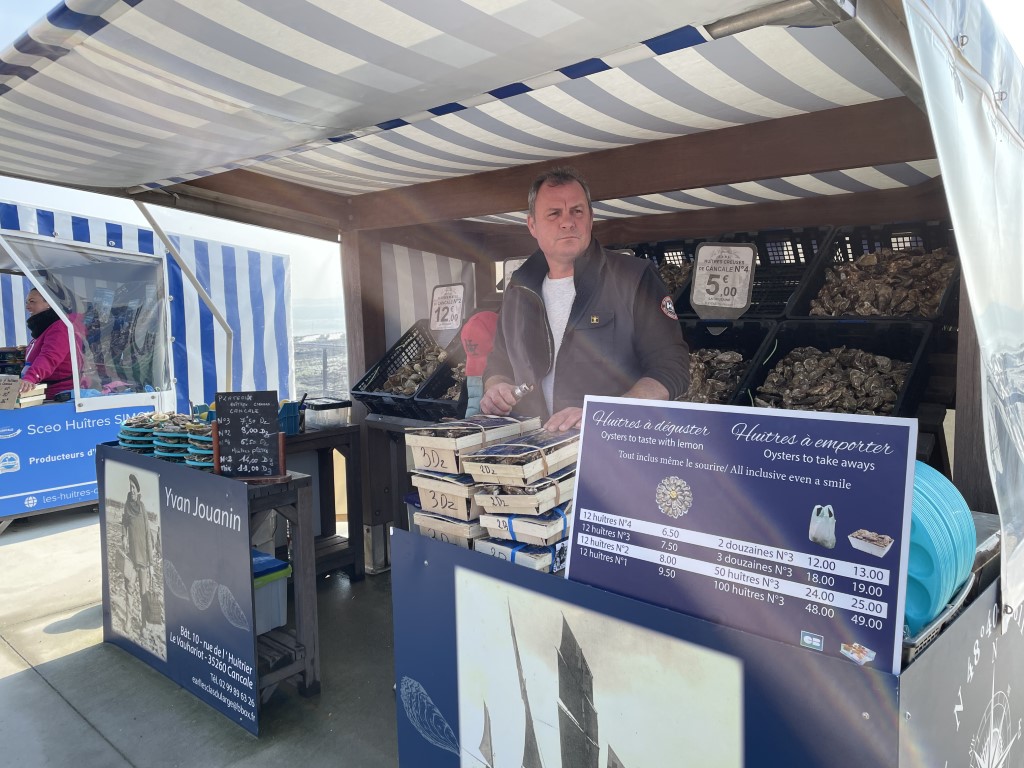 Yvan Jouanin oyster vendor at his seafront stall in Cancale, Brittany, selling fresh local oysters