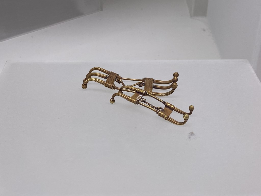 Ancient Etruscan gold fibulae on display at the Villa Giulia National Etruscan Museum, Rome