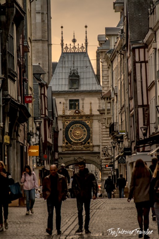 Gros-Horloge astronomical clock tower rising above a cobblestone street in Rouen, Normandy