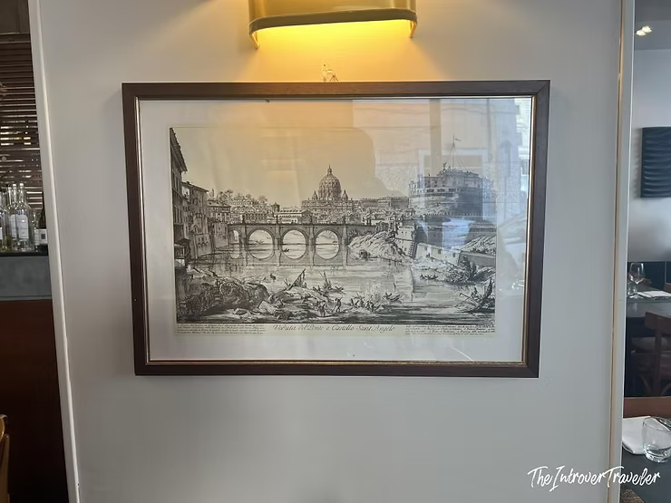 Framed Piranesi engraving of Ponte Sant'Angelo and St. Peter's on the restaurant wall