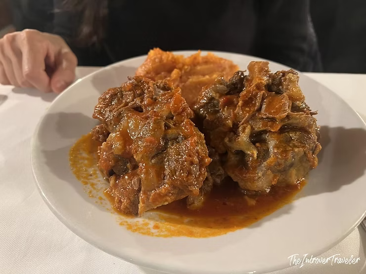 Disappointing coda alla vaccinara at Checco er Carettiere, served in a thin tomato sauce lacking depth