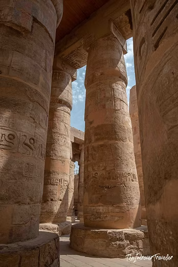 Towering hieroglyph-covered columns of the Karnak Temple Hypostyle Hall, Luxor Egypt