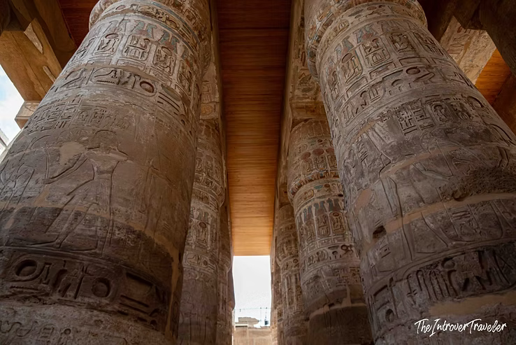 Massive hieroglyph-covered columns of the Karnak Temple hypostyle hall, Luxor, Egypt