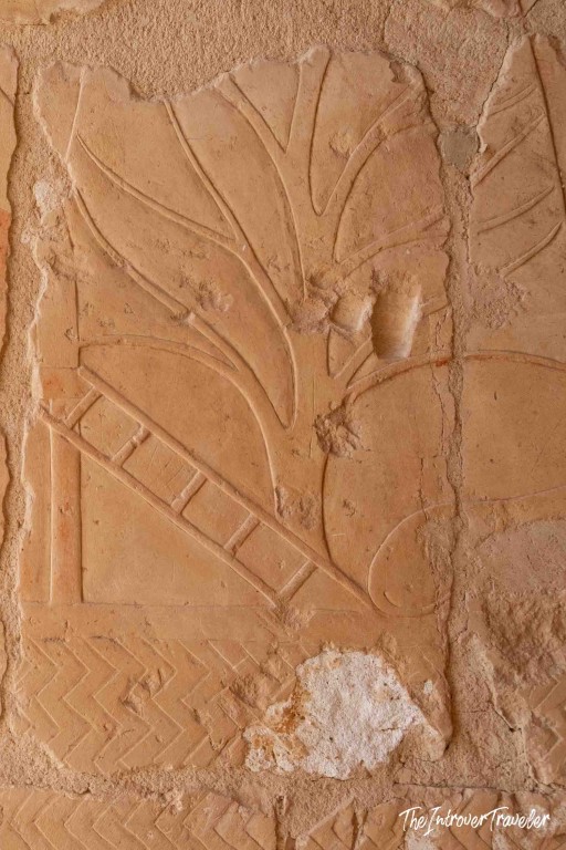 Ancient Egyptian sandstone relief carving of a tree and ladder at the Temple of Hatshepsut, Luxor