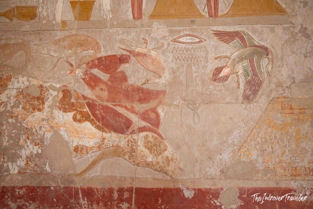 Colorful ancient Egyptian wall paintings with birds and hieroglyphs at the Temple of Hatshepsut, Luxor