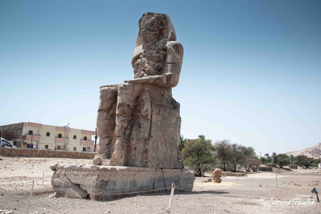 One of the Colossi of Memnon seated statues on the West Bank of Luxor, near Deir el-Bahari