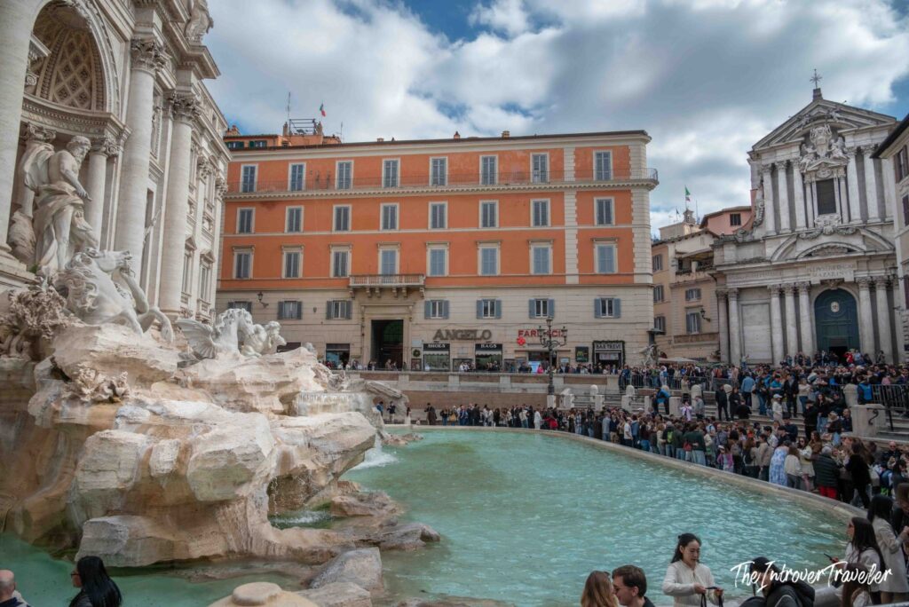 Trevi basin with the church of Santi Vincenzo e Anastasio behind the crowd, Rome