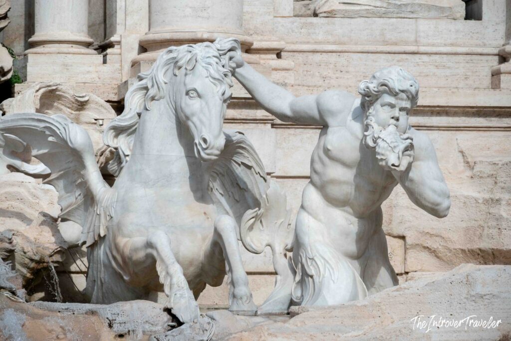 Calm winged sea horse and triton blowing a conch, Trevi Fountain, Rome