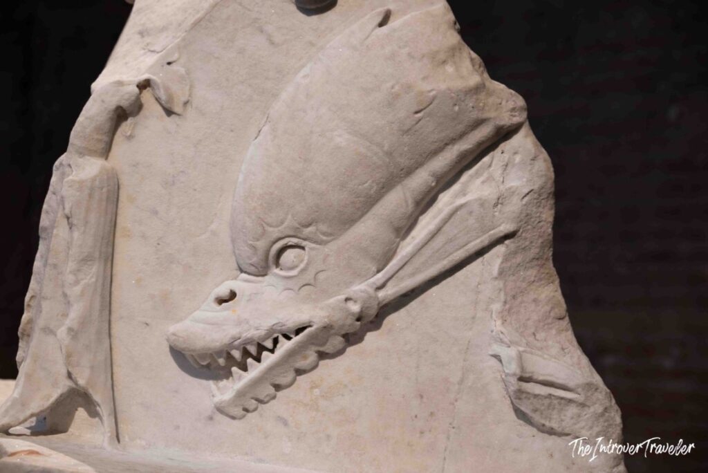 Marble relief of a sea creature with open jaws in the Oltre il Pantheon route, Pantheon, Rome